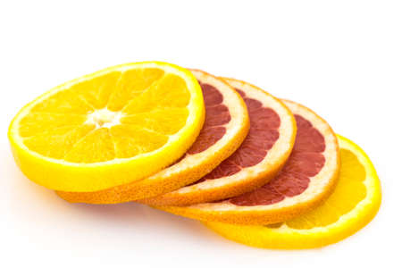 slices of orange and grapefruit isolated on white background.の写真素材