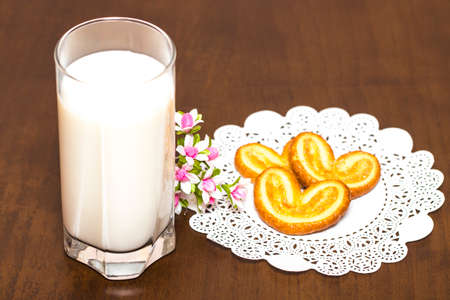 Cookies and a glass of milk - healthy breakfast. Wooden table. Closeup.の写真素材