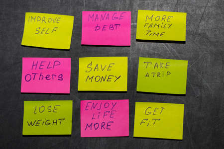 new year goals or resolutions - colorful sticky notes on a blackboardの写真素材