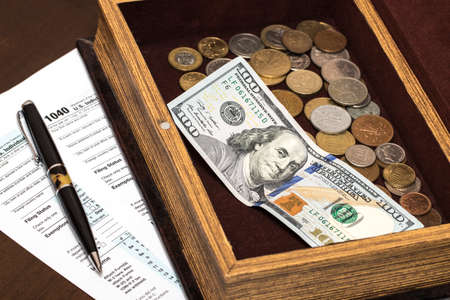 US 1040 tax form with pen, and coinsの写真素材