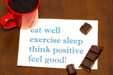 think positively , exercise, eat well, sleep - concept feel good - handwriting on a sheet of paperの写真素材