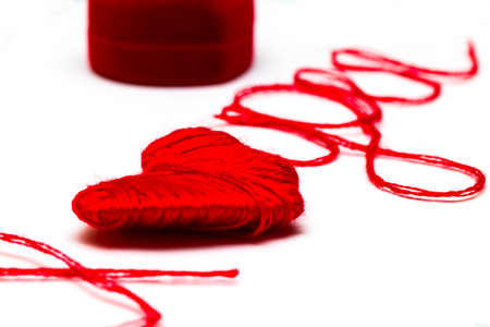 Love you words and heart symbol made of red thread on a white background for your Valentine's dayの写真素材