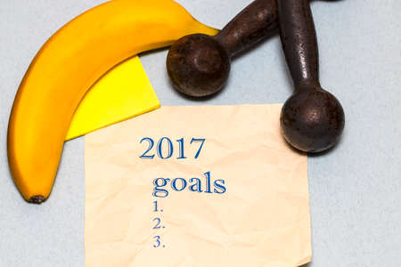 New years resolutions and goals for healthy lifestyle and nutrition, dumbbells, roulette, bananaの写真素材