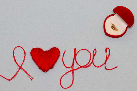 Love you words and heart symbol made of red thread on a white background for your Valentine's dayの写真素材