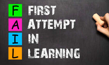FAIL acronym First Attempt In Learning handwritten with white chalk on blackboard.の写真素材