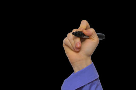 Hand holding marker isolated on black boardsの写真素材