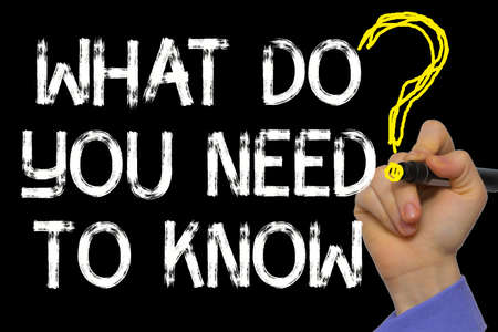 Hand writing the text: What Do You Need to Know?の写真素材