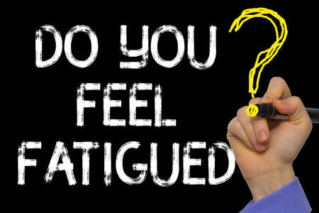 Hand writing the text: Do You Feel Fatigued?の写真素材