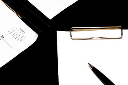 note book and calendar on black background.の写真素材