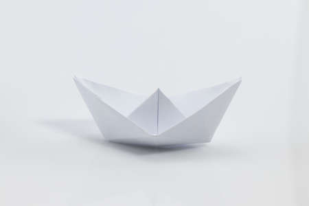 Close up origami ship isolated on white background.の写真素材