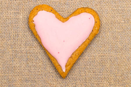baby cookie on burlap in a heart shape.の写真素材