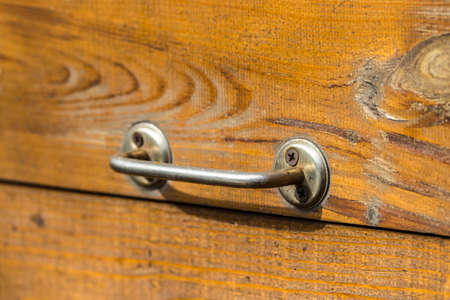 old wooden door with a handle in the background.の写真素材
