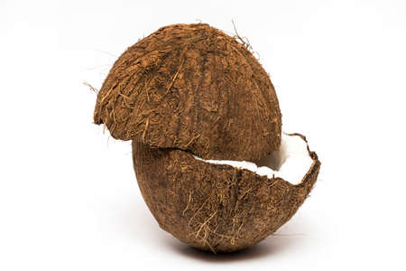 Coconut with a half on white background, closeup.