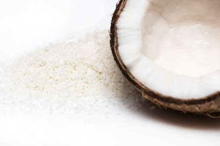 coconuts with coconuts flakes isolated on the white background.の写真素材