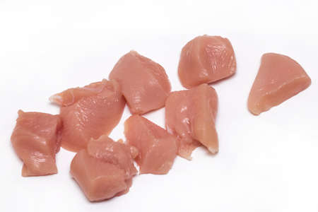 Top view of raw chicken fillet chunks isolated on white.の写真素材