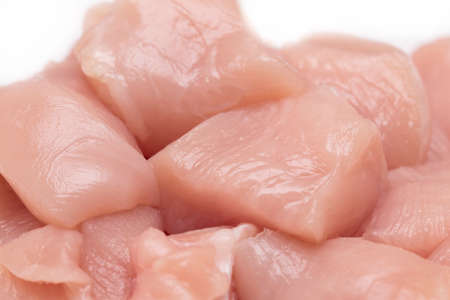 Top view of raw chicken fillet chunks isolated on white.の写真素材