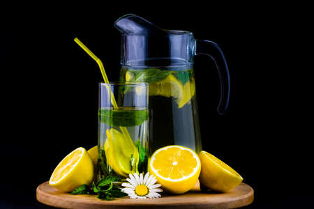 Fresh lemonade with lemon on wooden background.の写真素材