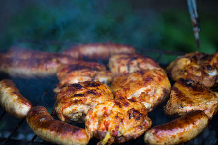 Chicken Sausages being grilled on an outdoor barbecue for that Special Smokey Outdoor Taste!
