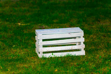 Empty wooden crate on green grass, outside.の写真素材