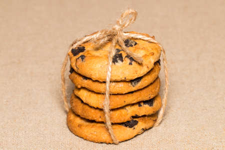 Chocolate cookie pieces and crumbs on background burlap.の写真素材