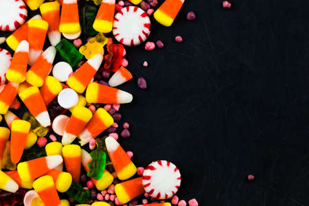 Colorful candies and  jelly on a black background background. Top view with copy space.の写真素材