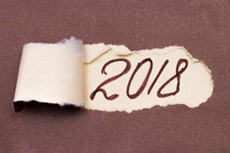 Text Planning 2018 appearing behind ripped brown paper.の写真素材