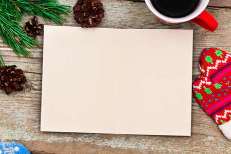 Holiday decorations and notebook with clean sheet for the list on wooden table, flat lay style. Planning concept.の写真素材