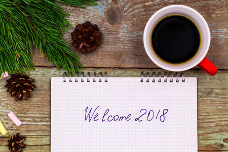New Year 2018 concept. notebook on wood table writing Welcome 2018.