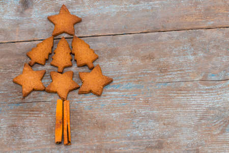 christmas tree made from gingerbread cookies on wooden background with copy space for text. holiday, celebration and cooking concept. new year and christmas postcard.の写真素材