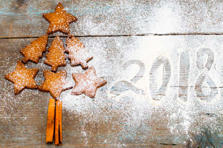 christmas tree made from gingerbread cookies  with figures 2018 on wooden background with copy space...