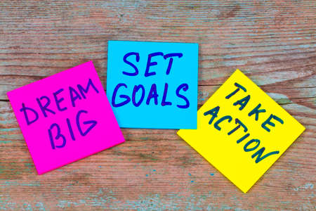 dream big, set goals, take action concept - motivational advice or reminder on colorful sticky notes on wooden background.の写真素材