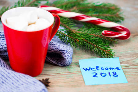New Year 2018 concept. Cup of coffee and sticky note on wood table writing Welcome 2018.の写真素材