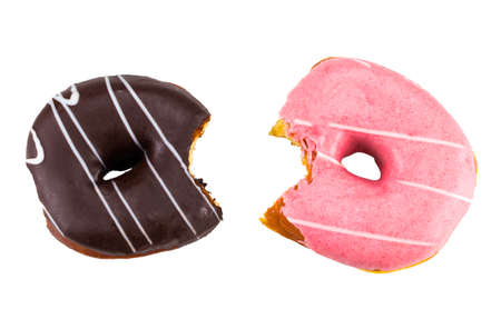 Bitten strawberry donut with colorful sprinkles and chocolate donut  isolated on white background. Top view.の写真素材
