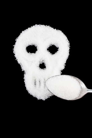 The skull made from sugar. Sugar Kills.Black  background. diabetes concept. Suggesting dieting concept. Unhealthy white sugar concept. Copy space. Space for text.の写真素材