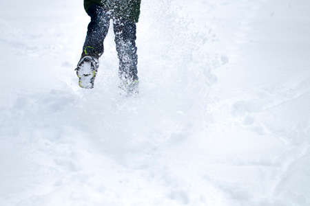 Legs of traveler standing in deep snow outdoor. Travel and discovery concept.の写真素材
