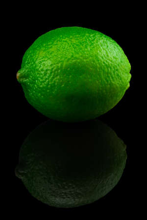 Fresh ripe lime isolated on black background.の写真素材