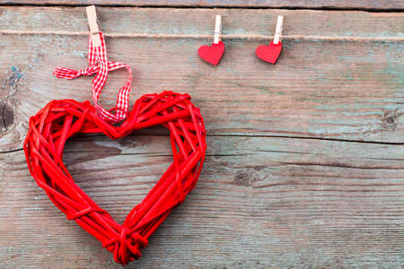 Valentine's day background with red hearts on wooden planks.の写真素材