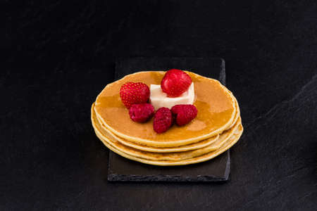  Pancakes with berry fruit and honey. Selective focus.