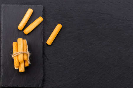 Crispy bread sticks on black stone background with copy space.の写真素材