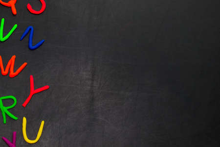 Black chalkboard with colorful letters, concept for education with copy space.の写真素材