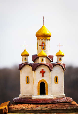 Miniature, hand-made, church on a background of sky.の写真素材