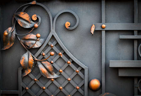 Details, structure and ornaments of forged iron gate. Floral decorative ornament, made from metal. Vintage metallic pattern. Decorative elements as a background.の写真素材