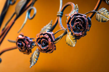 Details, structure and ornaments of forged iron gate. Decorative ornamen with roses, made from metal.の写真素材