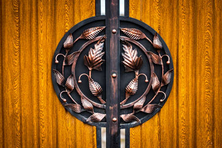 wooden gate with wrought iron elements close up.