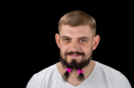 Funny cheerful bearded man standing and having fun over  black background.の写真素材