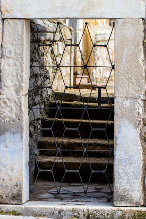 Stone wall entrance to a garden, security closed entrance door.
