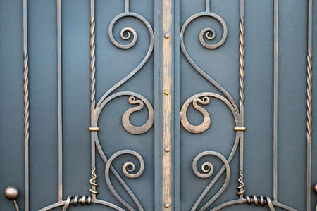 magnificent wrought-iron gates, ornamental forging, forged elements close-up.
