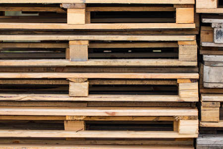 Stacks of Wooden pallets for industrial transportation by trucks.