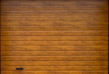 Wooden wall of modern rural garage with the automatic lifted gate.の写真素材