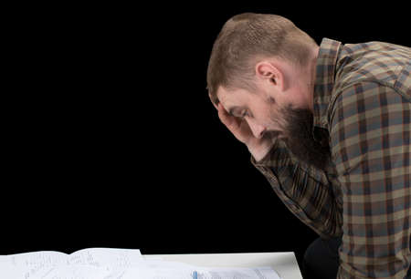 Busy man investment consultant analyzing company annual financial report balance sheet statement. Worried corporate employee working with documents graphs. Stock market, office, tax, economy concept.の写真素材